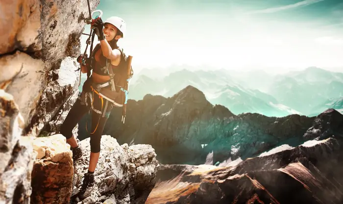 An image of a lady climbing a mountain